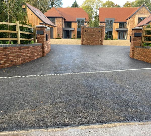 fresh surface driveway of two modern built brick and wood homes