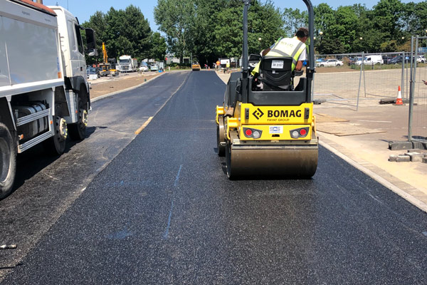 surface dressing of road undertaken using yellow roller