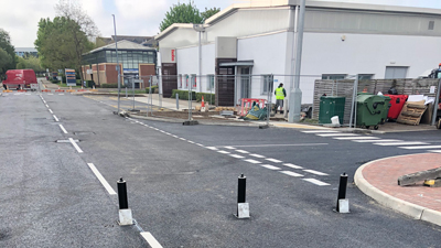 road surfacing on access road into industrial estate with bollards up